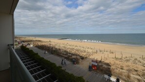 A beach view from a balcony with a wooden deck, a sandy beach, and the ocean. - Edgewater House - Ocean Front Units With Spectacular Views! (Rehoboth Beach)