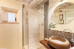 Bathtub, hair dryer, slippers, bidet