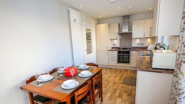 A compact kitchen with a dining area. - Devonvale Place by Interhome (Kinross)