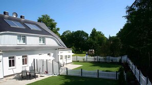 Enjoy the serene atmosphere of this two-story house with a spacious patio and beautifully manicured lawn.