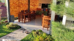 A modern interior with a dining area, a kitchen, and a living space. - Singgahan Bungalow by ecommerceloka (Penida Island)