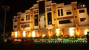 A multi-story hotel with a modern architectural design, featuring a prominent entrance with a covered walkway and decorative lighting. - Hotel Imperial (Ujjain)