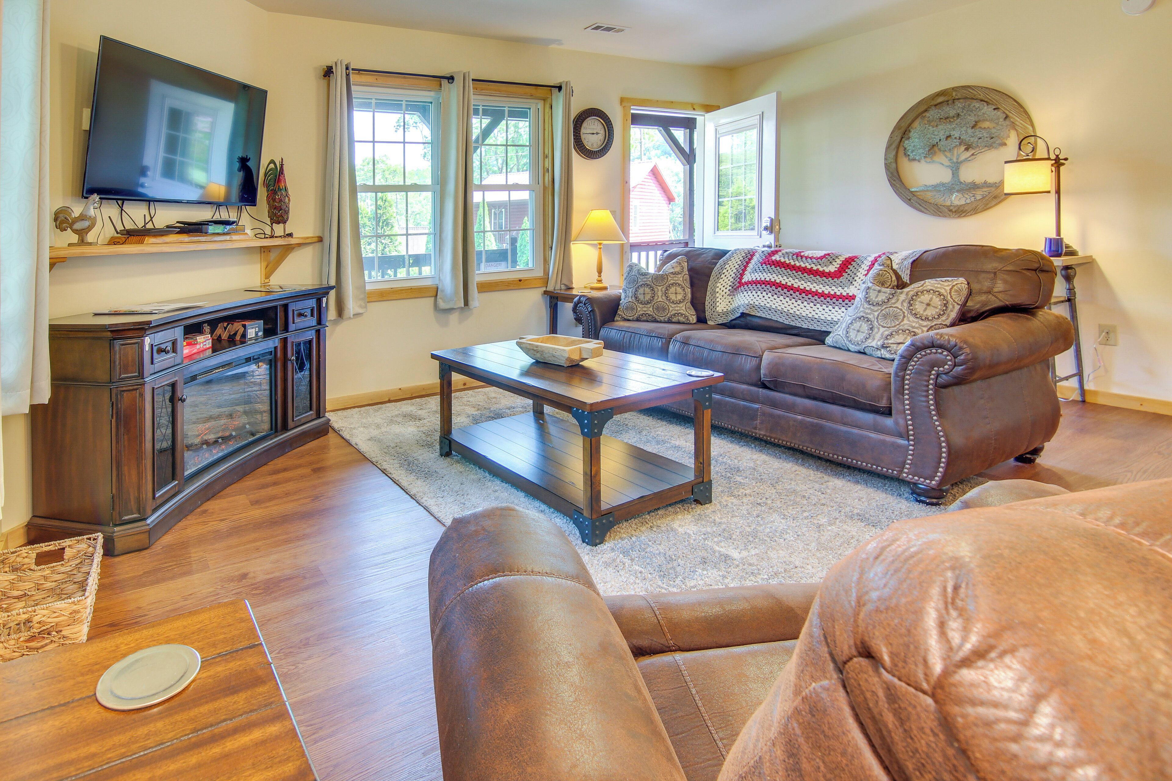 A living room with a television, sofa, coffee table, and a fireplace.