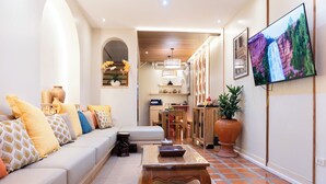 A modern living room with a sofa, coffee table, and TV. - Private house in city center near Sukhumvit-Rama4 (Khwaeng Khlong Toei)