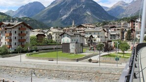 A mountainous town with traditional buildings, a central square, and a train track. - San Anton by Interhome (Bormio)