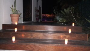 A set of wooden steps leading up to a building entrance, with candles placed at intervals. - COSY BEDROOM 23m2. Adults Only (agde)