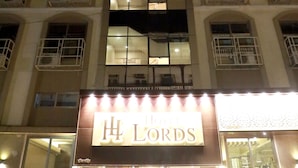 A hotel with multiple floors, balconies, and a prominent illuminated sign reading "H LORDS". - Hotel Lords Mumbai (Mumbai)