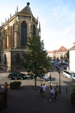 A historic building with large windows and a pointed roof.