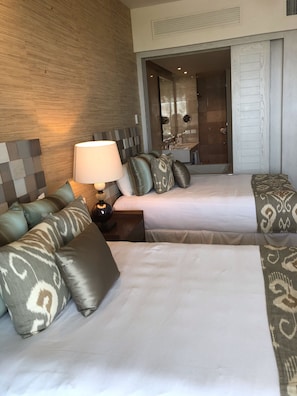 A hotel room with two beds, a sofa, a lamp, and a bathroom visible through an open door. - Ocean front Resort  StudioMaster  (2A&2K) with Golf (2x1) in Mayan Palace in AP (Acapulco)