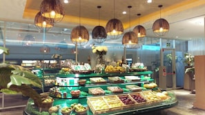 A buffet with various fruits and vegetables displayed in baskets and trays, with hanging spherical lights above. - Ocean front Resort  StudioMaster  (2A&2K) with Golf (2x1) in Mayan Palace in AP (Acapulco)