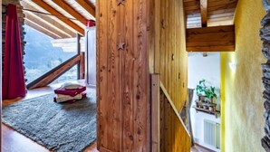 A wooden interior with a sloped ceiling, a stone wall, and a view of the outdoors. - Maison Chez Nous by Interhome (Sarre)