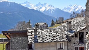 A stone building with a sloped roof, a small window, and a chimney. - Maison Chez Nous by Interhome (Sarre)