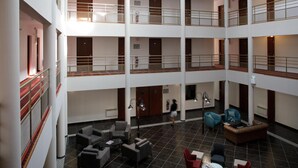 A multi-level atrium with a central open space, multiple balconies, and seating areas.