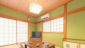 A traditional Japanese room with tatami flooring, shoji screens, a wooden ceiling, and a television on a low stand. - USJ / Quiet Private Japanese Traditional House,  close to Osaka fish market! (Osaka)