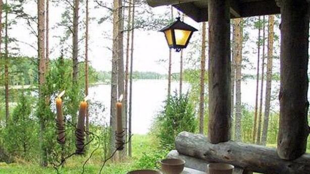 A rustic wooden table with a view of a lake and forest. - Näätämö by Interhome (Asikkala)