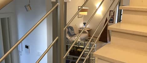 A staircase with a metal railing leading to a landing area.