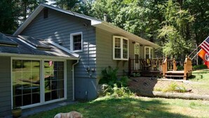 A house with a garage, a covered porch, and a small deck. - River Front Vacation Rental Property On The Clarion River in Clarington, Pa    (Clarington)