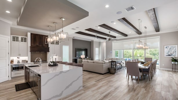 A spacious kitchen with a large island, modern appliances, and pendant lighting. - Reunion Fantasy | Games Room, Secret Playroom, English Pub Bar (Kissimmee)