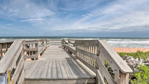 A wooden boardwalk leading to a beach with a sign reading "South Beach". - NEW !  Ocean Front Paradise  @  South Beach Condos with Amazing Views !  (Flagler Beach)