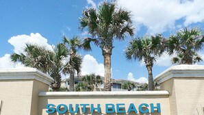 A sign reading "SOUTH BEACH" with palm trees in the background. - NEW !  Ocean Front Paradise  @  South Beach Condos with Amazing Views !  (Flagler Beach)