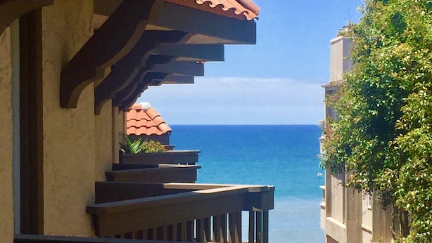 A balcony with a view of the ocean, wooden railings, and a tiled roof. - Ocean View from Living Room & porches -last min special for Nov and Dec!  (Solana Beach)