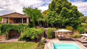 A stone house with a pool, surrounded by lush greenery and a large tree. - Fontblanche, Provencal estate for happy reunions (Gordes)