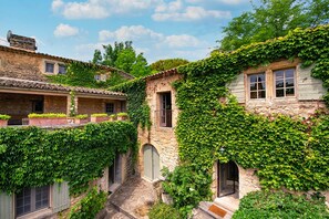 A narrow alley with stone buildings covered in ivy, featuring small windows and doors. - Fontblanche, Provencal estate for happy reunions (Gordes)