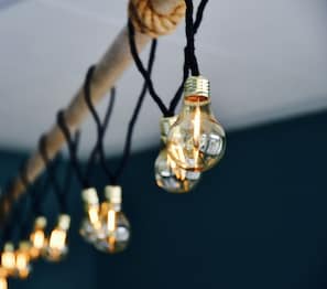 A close-up of a string of light bulbs with visible filaments and a warm glow. - Eco Camp Norway - Hostel (Smøla)