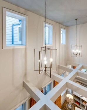 A modern interior with white walls, multiple windows, and geometric pendant lighting. - Bachelorette HQ + Roof Deck, Walk to Broadway 5bath, 3kings,4 Queen, 8 twins (Nashville)