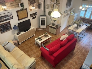 Télévision, cheminée, lecteur de DVD, livres