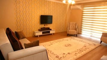 Deluxe Apartment, 1 King Bed, Hill View | Living area | 102-inch LCD TV with premium TV channels, TV