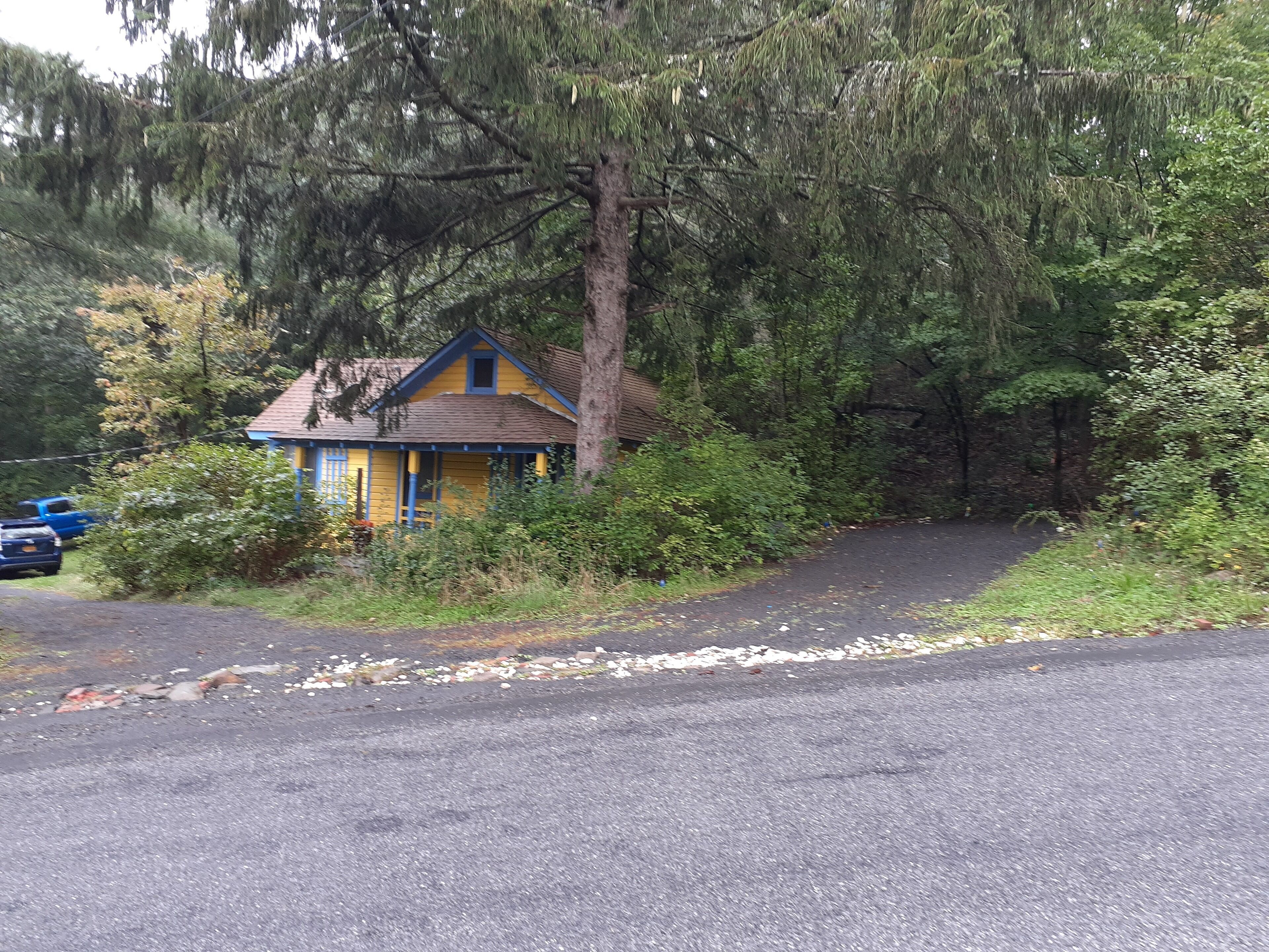 view of cottage from the road and parking to the right