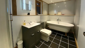 A modern bathroom with a vanity, sink, and bathtub. - Tigh a Chabar, Savary. Nr Lochaline.  Cosy cottage, sleeps 4.  Sea views. (Morvern, Argyll)