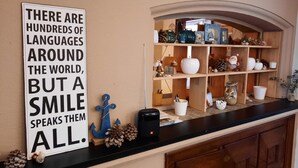 A kitchen counter with a sign stating "THERE ARE HUNDREDS OF LANGUAGES AROUND THE WORLD, BUT A SMILE SPEAKS THEM ALL." - Spacious vacation home with covered patio and sun terrace (Middelkerke)