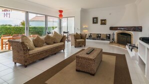 A spacious living room with a sofa, armchairs, and a fireplace. - Arribas Villa by Interhome (Guia)