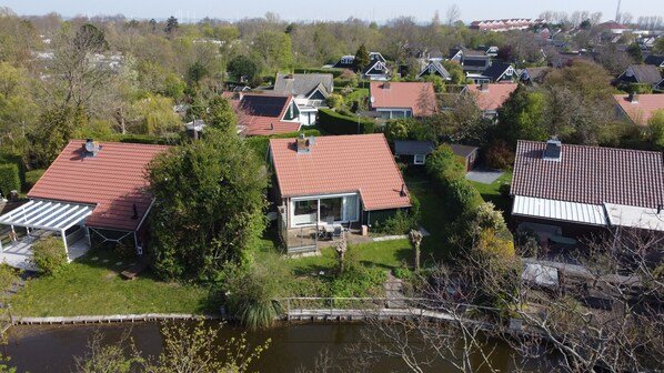 A residential area with houses, a pond, and a bridge.