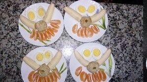 Four plates of food with boiled eggs, salmon, and breadsticks. There are also two glasses of a white beverage and a bowl of green dip. - Hotel Nirala (Darjeeling)