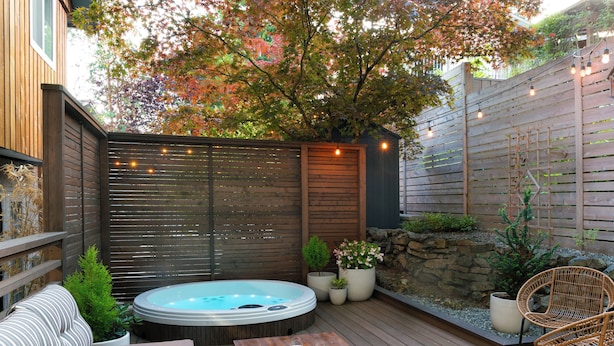 A wooden deck with a hot tub, seating area, and potted plants. - ★Ocean View Loft w/ Dedicated Hot Tub in Departure Bay. Treat Yourself Book Now★ (Nanaimo)