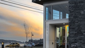 A modern building with a glass entrance and a sign reading "drip". - ★Ocean View Loft w/ Dedicated Hot Tub in Departure Bay. Treat Yourself Book Now★ (Nanaimo)