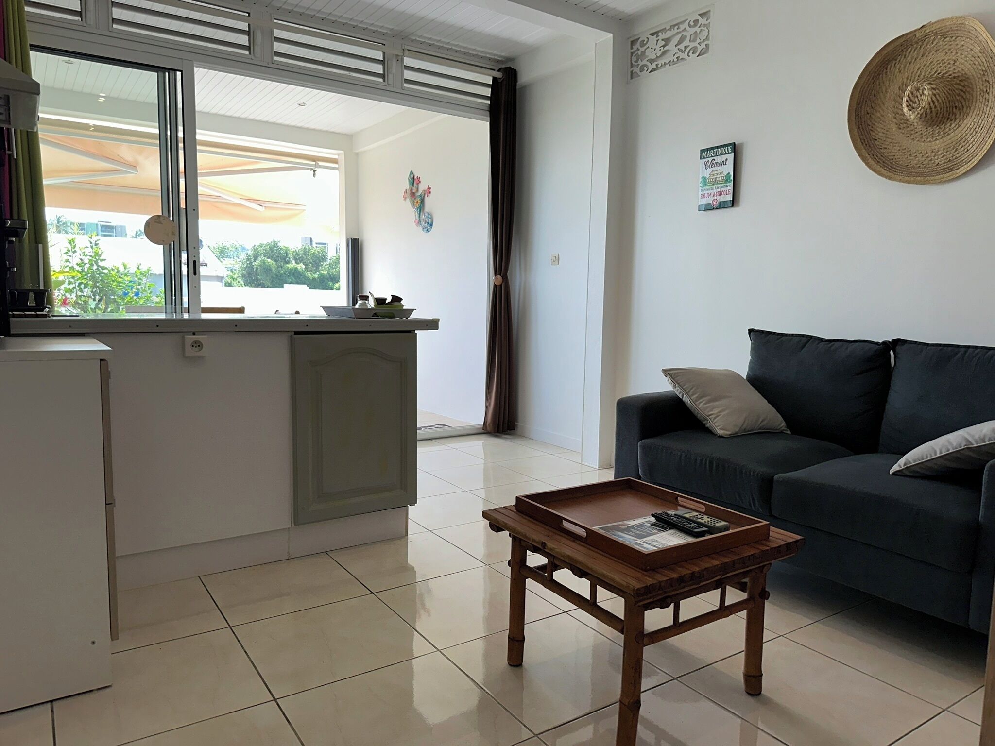 A compact living space with a kitchenette, a sofa, and a coffee table.