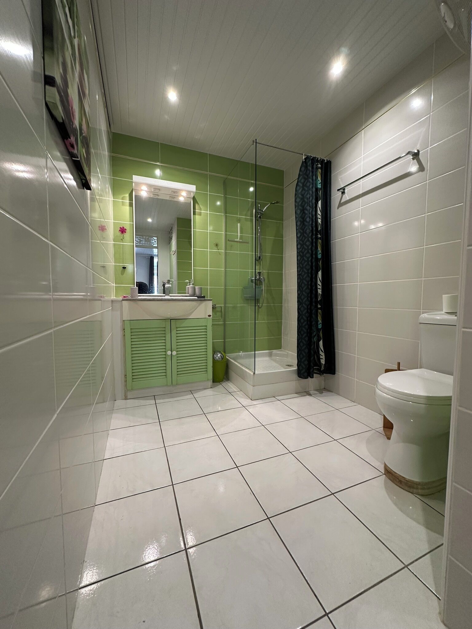 A bathroom with a shower, toilet, and sink.