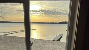 A room with a view of a beach and a pier. -  Escape to the Holiday House. Serenity of Sunsets, Lakeside boat dock included. (Lewiston)