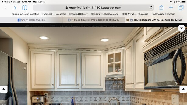 A modern kitchen with white cabinets, a built-in microwave, and a stainless steel range hood. - Music Row Condo in Spence Manor/Guitar Shaped Pool (Nashville)