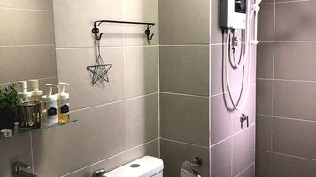 A modern bathroom with a toilet, sink, and shower.