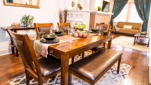 A dining area with a wooden table set for six, surrounded by leather chairs. - Quiet Street 10 minutes from Downtown Indy! #1 (Indianapolis)