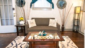 A living room with a sofa, coffee table, and decorative items. - Quiet Street 10 minutes from Downtown Indy! #1 (Indianapolis)
