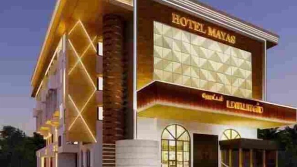 A modern hotel with a prominent sign reading "HOTEL MAYAS" and a large glass facade. - Hotel Mayas (Tiruchirappalli)