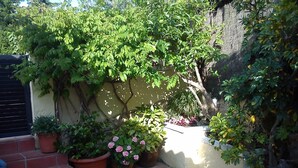 A patio area with potted plants and a small staircase. - Chalet with mountain views and private pool, ideal for families.  (viladecavalls)