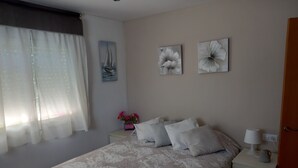 A bedroom with a bed, nightstands, a lamp, and artwork on the wall. - Chalet with mountain views and private pool, ideal for families.  (viladecavalls)
