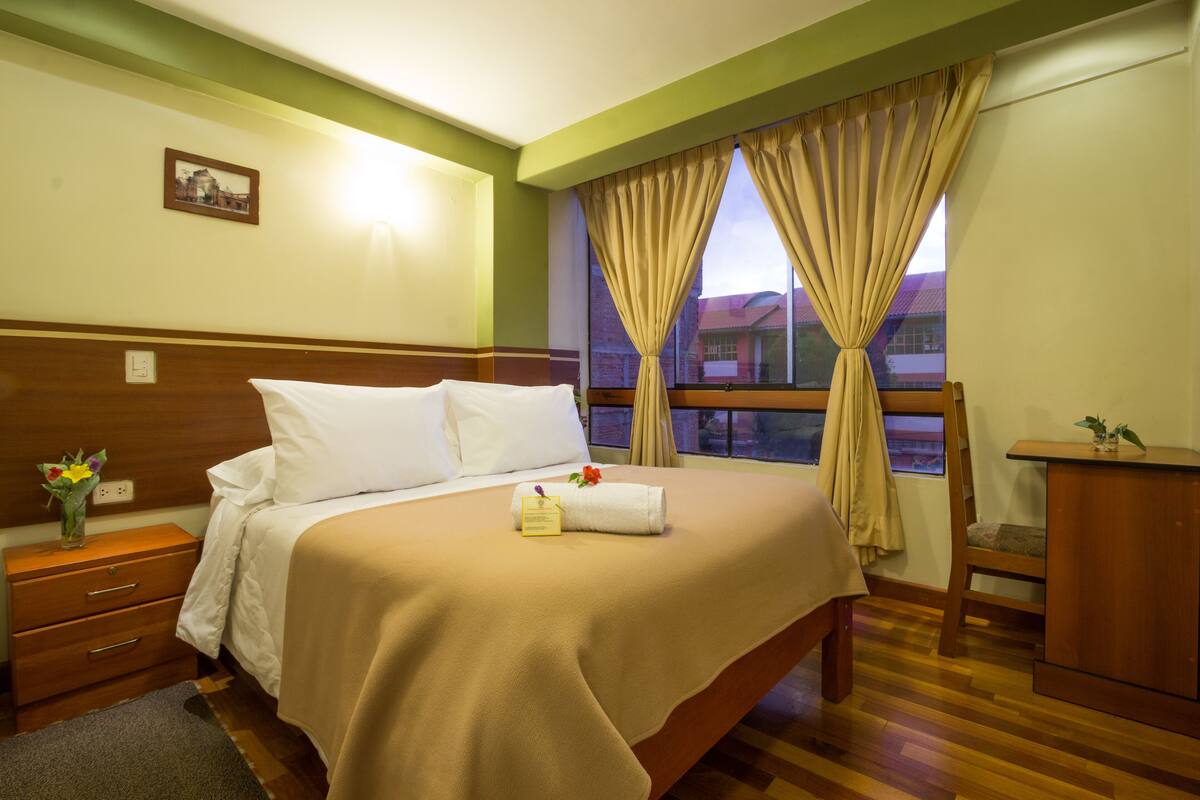 Hypo-allergenic bedding, down duvets, desk, laptop workspace